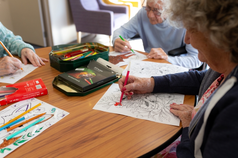 people colouring in at dementia care auckland facility ambridge rose