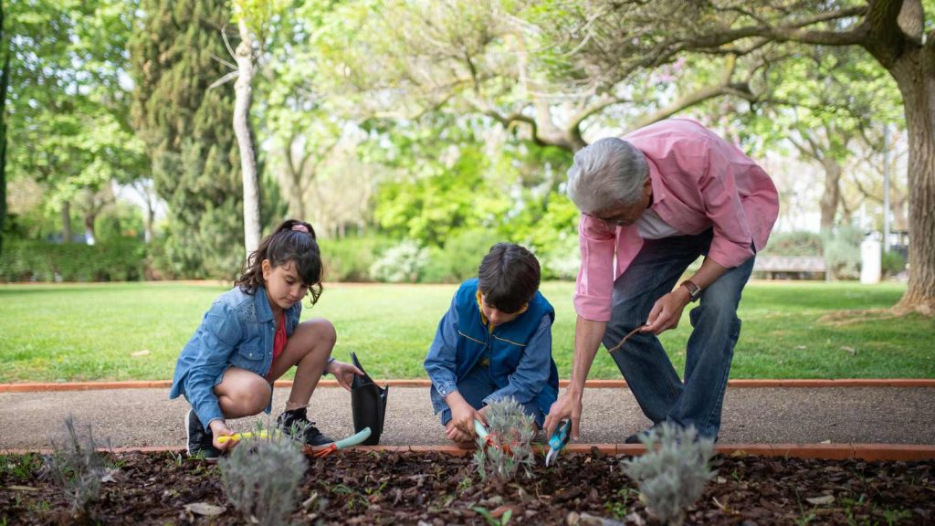 Grandparent with their grandchildren gardening